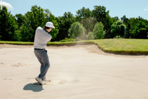 Man playing golf on golf course Man playing golf on golf course